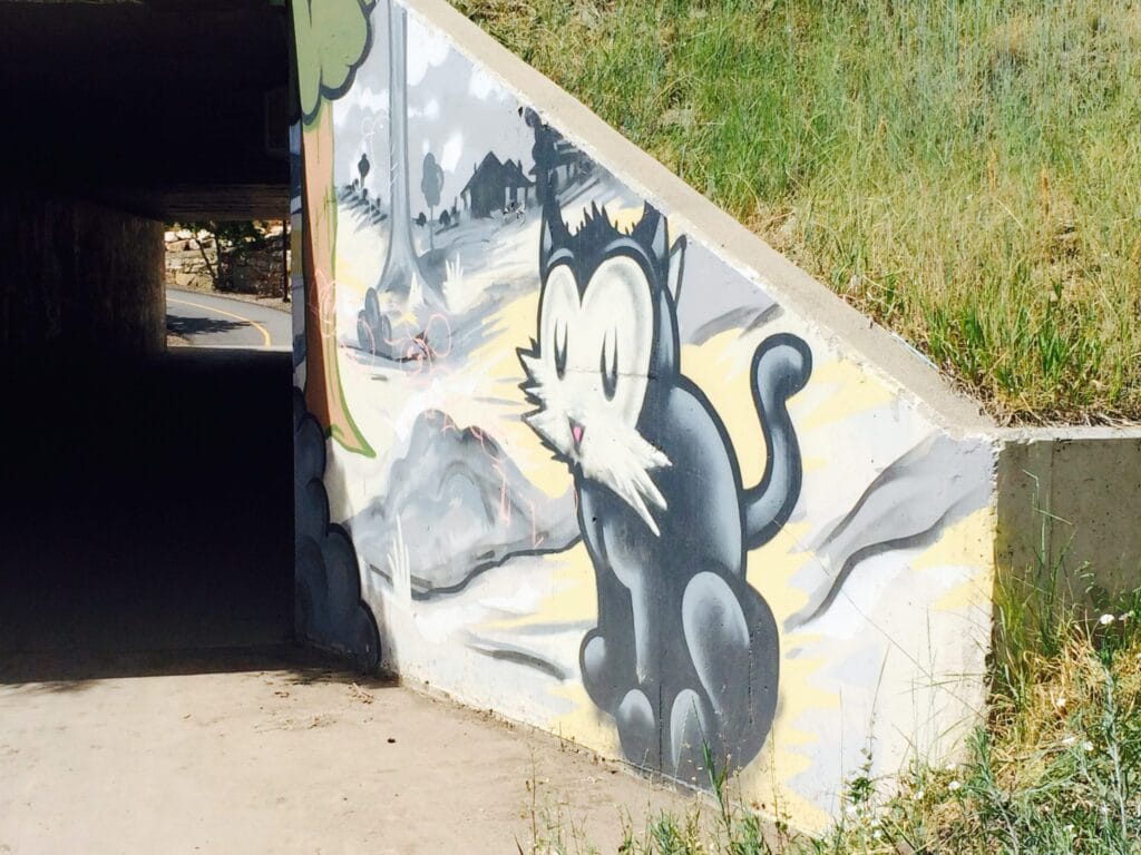 Street Art painting of a nostalgic pussy cat in artist Trent Call's signature cartoon style.