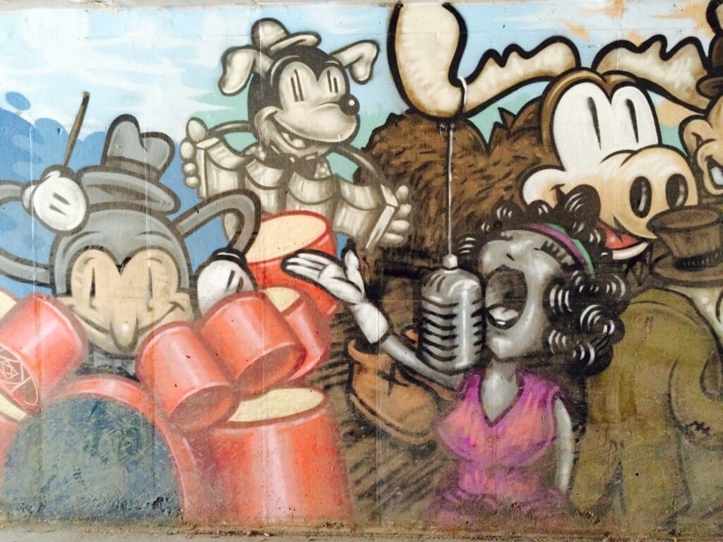 Street Art painting of a nostalgic singer with her band in artist Trent Call's signature cartoon style.