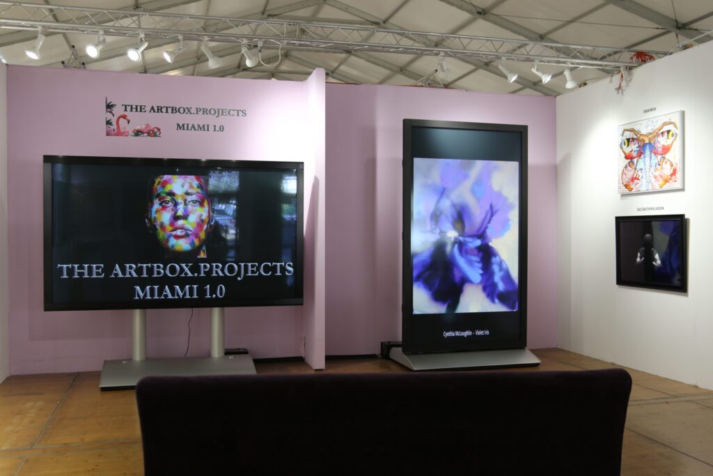 Photo of the Artbox Project's booth at the Spectrum Miami show in Florida, 2016. Violet Iris by artist,Cynthia McLoughlin is highlighted.