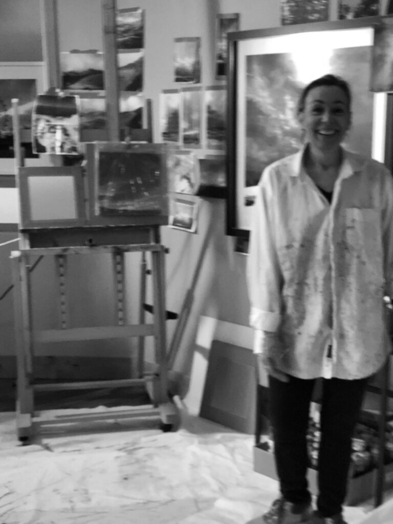 Black and white photo of Cynthia McLoughlin in her studio.