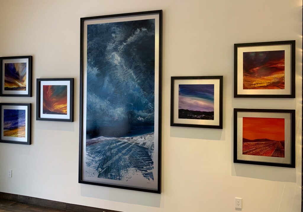 Gallery wall detail of Celestial Rhapsody and my sunset paintings!