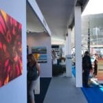 Pink, maroon and gold painting hanging on the wall of the Art UpClose booth at the Monaco Yacht Show, 2019.