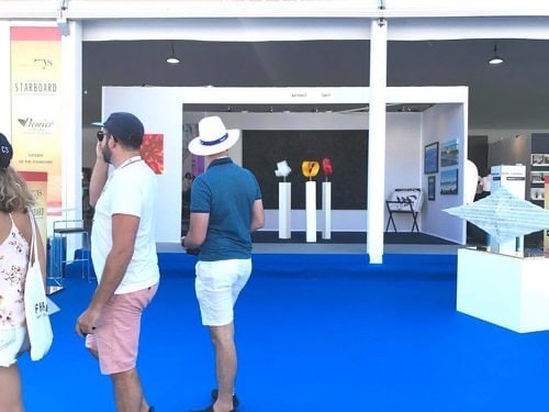 Buyers looking into the Art UpClose booth at the Monaco Yacht Show, 2019.