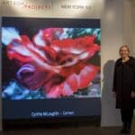 Cynthia McLoughlin, artist along side of the digital image of her painting, Carmen, at the Stricoff Gallery in Chelsey, NYC in 2018.