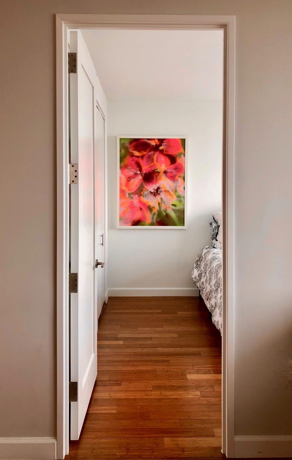 Pink, vertical floral hangs in the bedroom.