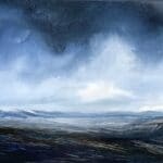Deep blue storm clouds drift over the valley and distant mountains, deep shadows in the foreground create more drama in this horizontal oil painting by artist Cynthia McLoughlin.