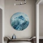 A contemporary mountain oil painting, oil on a circular brushed aluminum panel, by artist Cynthia McLoughlin