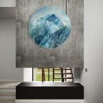 A contemporary mountain oil painting, oil on a circular brushed aluminum panel, by artist Cynthia McLoughlin