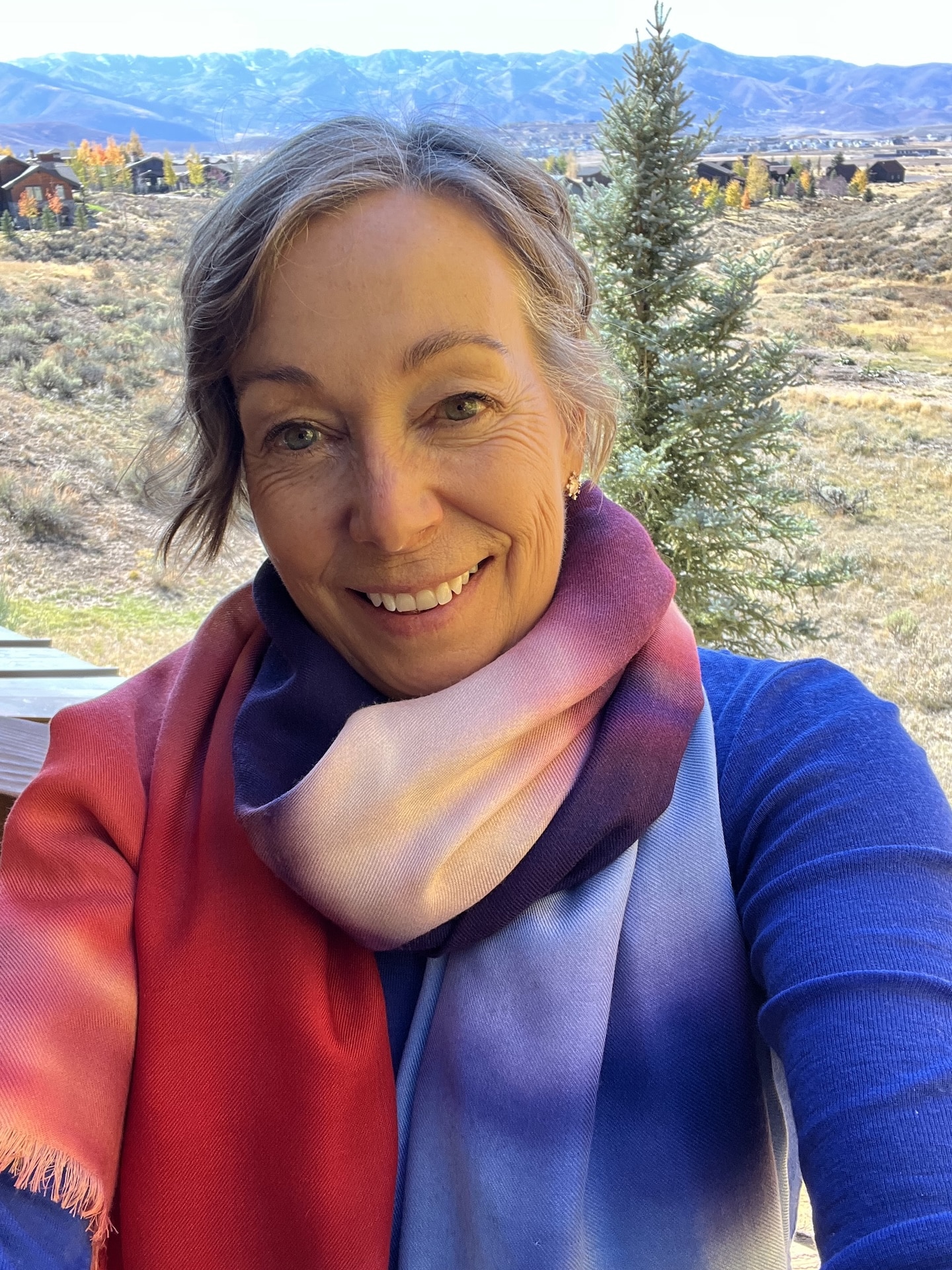 Limited edition cashmere/silk/wool scarf modeled by artist Cynthia McLoughlin, based on her painting Above Us Only Sky.