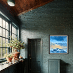 Evening Glow by Cynthia McLoughlin displayed in a rustic green-walled interior, featuring a contemporary oil painting of snow-capped Wasatch mountains at sunset with a luminous blue and gold sky, Park City, Utah.