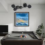 Evening Glow by Cynthia McLoughlin: modern landscape oil painting of the Wasatch mountains at sunset, shown in a stylish home setting above a pool table, with vibrant blue and gold sky, created in Park City, Utah.