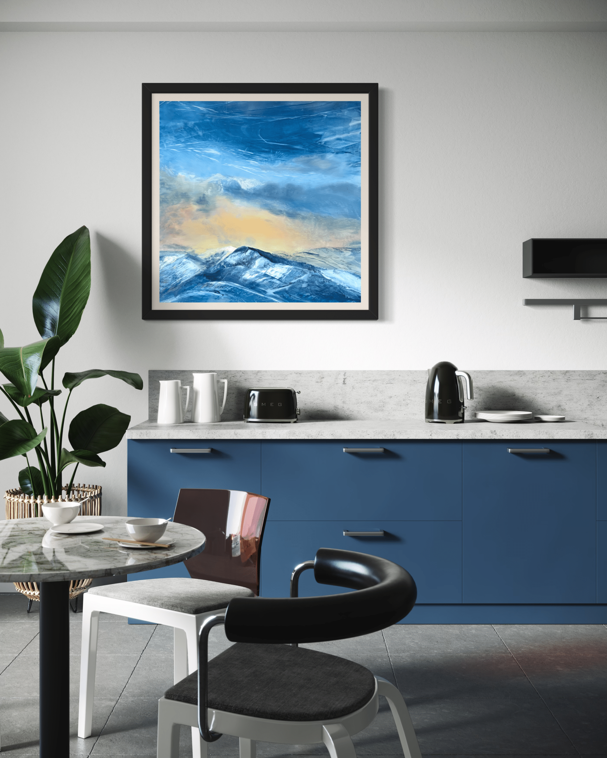Evening Glow by Cynthia McLoughlin: contemporary landscape oil painting of snow-capped Wasatch mountains at sunset, featuring luminous blue and gold sky, displayed in a modern kitchen with blue cabinets, Park City, Utah.