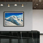 Contemporary mountain painting 'Powder Dream' hanging above a sleek, black marble reception desk in a modern corporate or residential lobby with concrete and wood paneling accents.