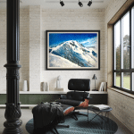 'Powder Dream' oil painting hanging in a contemporary, sunlit reading nook above a bookshelf, featuring a black leather Eames chair and ottoman, a black accent table, and an exposed white brick wall.