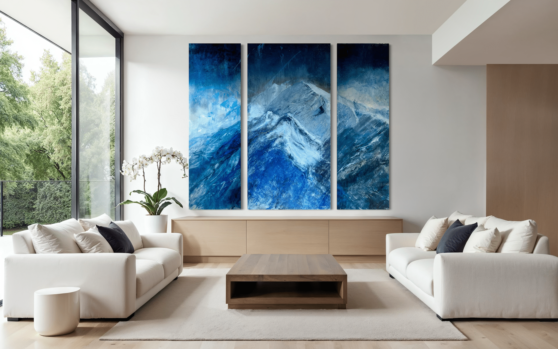 Triptych Celestial Drift with luminous sky and atmospheric mountai forms displayed in a contemporary living room.