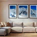Triptych Landscape oil painting of the iconic Pipeline chute in Utah's Wasatch Mountains, featuring a steep, dramatic ski line beneath an expansive, glowing sky rendered in expressive, layerd tones of deep blue,set in a modern family room.