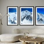 Triptych Landscape oil painting of the iconic Pipeline chute in Utah's Wasatch Mountains, featuring a steep, dramatic ski line beneath an expansive, glowing sky rendered in expressive, layerd tones of deep blue set in a contemporary living room.