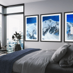 Triptych Landscape oil painting of the iconic Pipeline chute in Utah's Wasatch Mountains, featuring a steep, dramatic ski line beneath an expansive, glowing sky rendered in expressive, layerd tones of deep blue, set in a chic city bedroom.