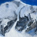 Center Panel of a Triptych Landscape oil painting of the iconic Pipeline chute in Utah's Wasatch Mountains, featuring a steep, dramatic ski line beneath an expansive, glowing sky rendered in expressive, layerd tones of deep blue.