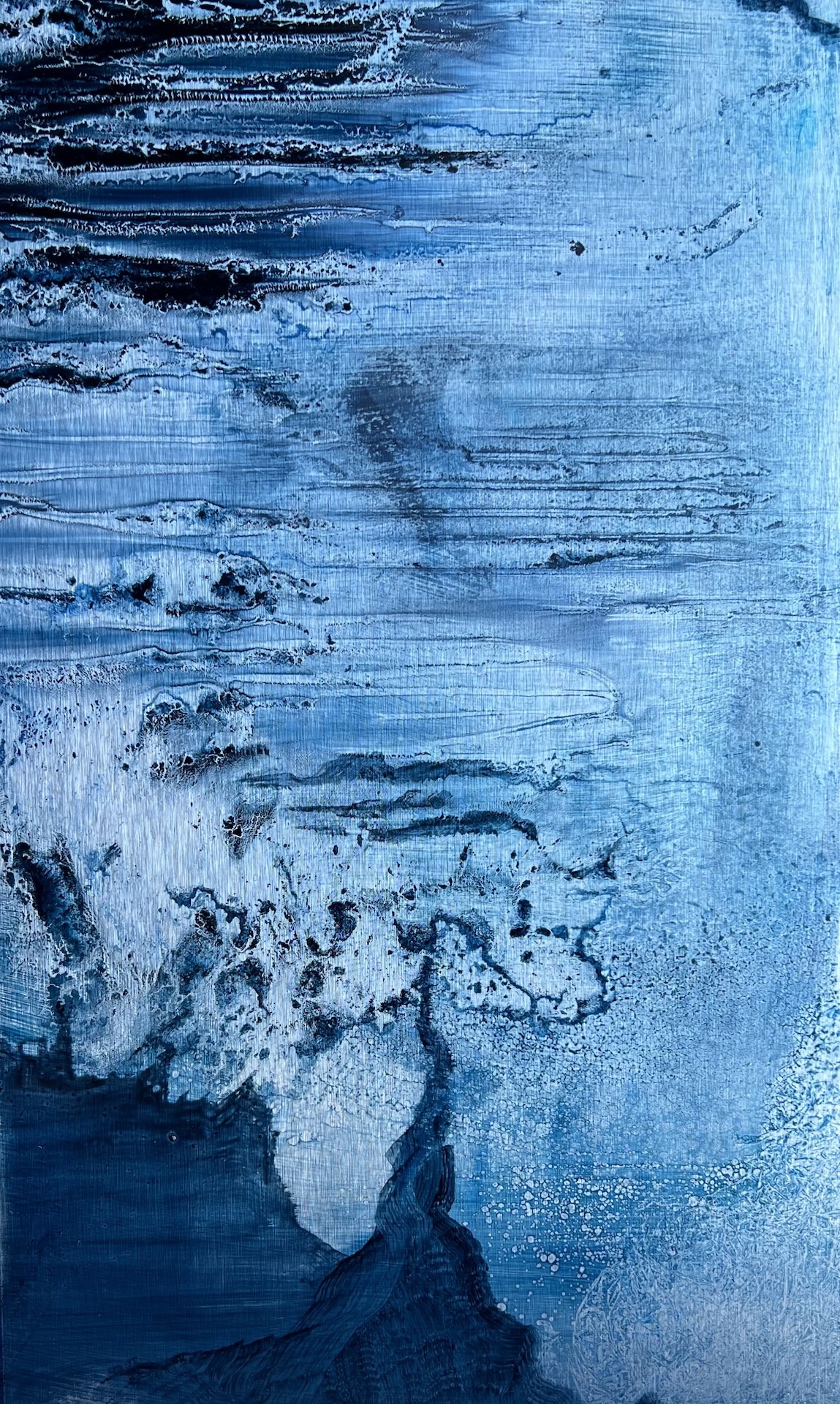 Pale blue abstract painting with scraped horizontal layers, exposed textures and darker forms that suggest eroded rock, water and a shifting shoreline.